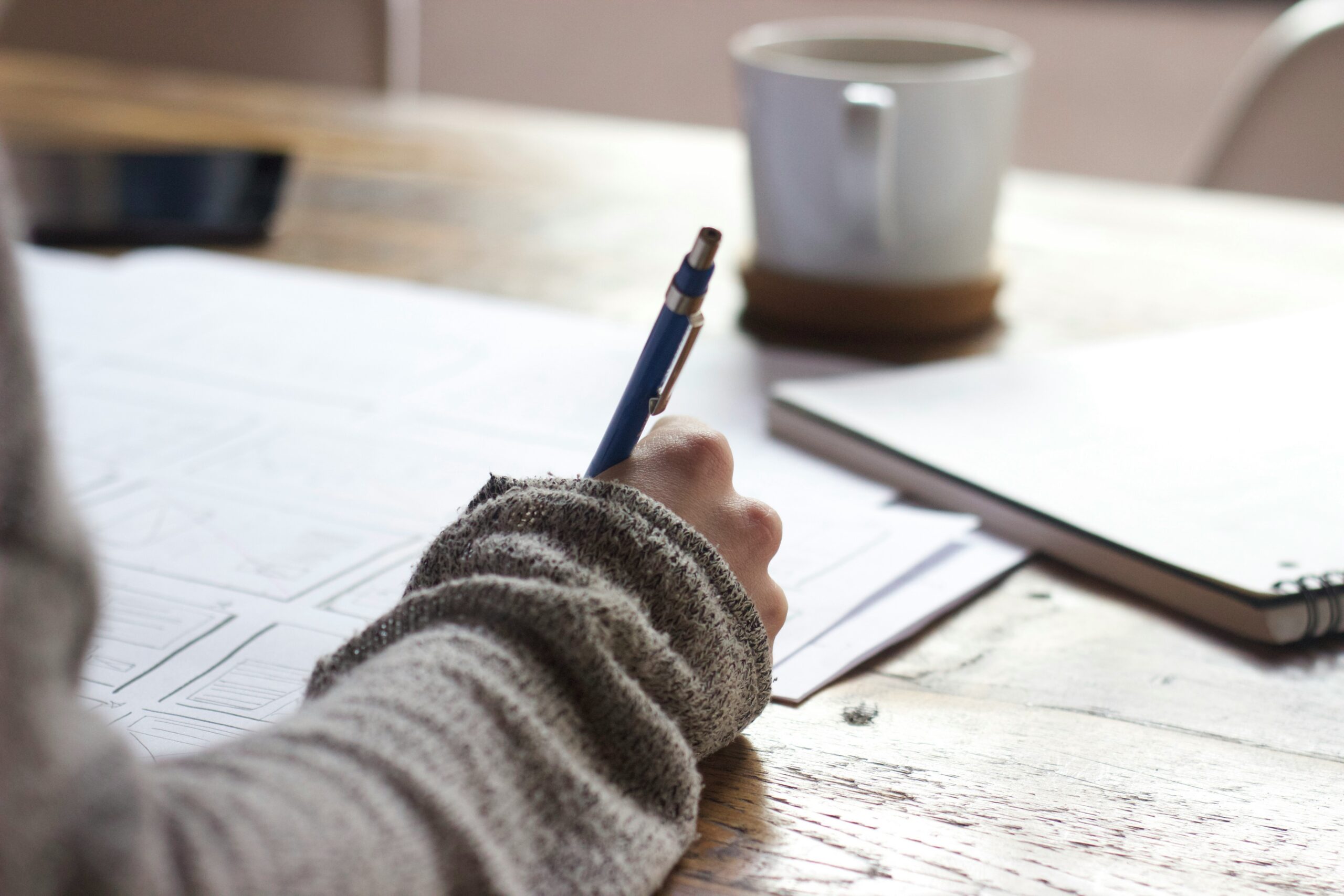 student writing with pen and paper